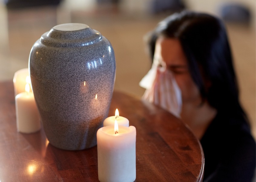 cremation urn and woman.jpg