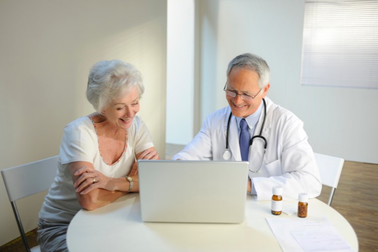 Doctor explaining DNA banking options to an elderly patient