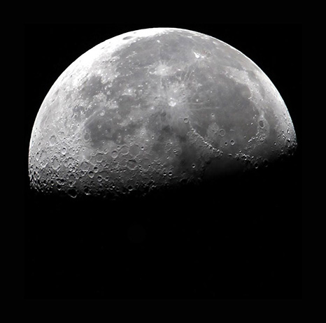 Half-moon image symbolizing a celestial memorial spaceflight tribute