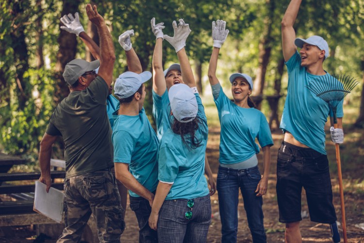 A happy team of volunteers celebrating during a military foundation event, showcasing their commitment to supporting veterans and military causes