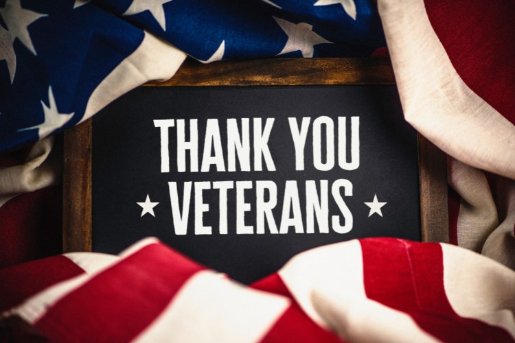 A "Thank You Veterans" sign surrounded by the American flag, symbolizing gratitude and honor for veterans on Veterans Day